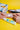woman applying rubber ducky sunscreen mineral lotion to her arm on a yellow background
