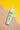 rubber ducky mineral sunscreen shown on studio background with yellow and beach sand